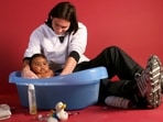 This photo taken in September 2007 shows a 20-year-old Lionel Messi helping to bathe Lamine Yamal, who was merely six months old at the time during a photo session. This photo taken in September 2007 shows a 20-year-old Lionel Messi helping to bathe Lamine Yamal, who was merely six months old at the time during a photo session.