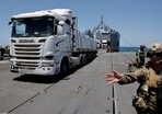 As bombs thunder in Gaza, just across the border in southern Israel truck driver Itzik waits in a barbed-wire protected parking lot for his delivery to clear inspection into the hunger-stricken territory.(Reuters ( relevant image ) )