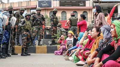 Paramilitary personnel stand guard as people stage a protest against the mass burial of Kuki-Zomi people killed in Manipur’s ethnic violence (File Photo) Paramilitary personnel stand guard as people stage a protest against the mass burial of Kuki-Zomi people killed in Manipur’s ethnic violence (File Photo)