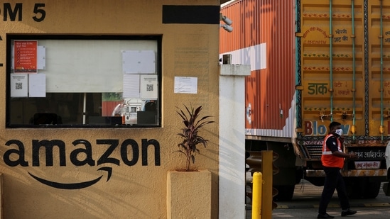 A man inspects trucks before they enter an Amazon storage facility on the outskirts of Mumbai, India.(Reuters)