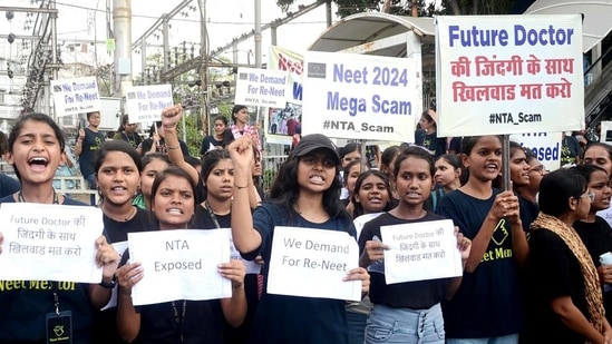 Students holding placards protest against the alleged irregularities in the NEET examination, in Bhopal on Friday. (ANI)