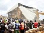 People and rescuers gather at the scene of a collapsed two-storey building in Jos, Nigeria, Friday, July, 12, 2024. People and rescuers gather at the scene of a collapsed two-storey building in Jos, Nigeria, Friday, July, 12, 2024.