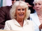 Gracing the event with her presence, Queen Camilla took her seat in the Royal Box in white, greeting the crowd with a wave. (The Associated Press)