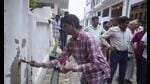 A team of government agencies putting a red mark on a house in Lucknow’s Rahim Nagar. (HT Photo) A team of government agencies putting a red mark on a house in Lucknow’s Rahim Nagar. (HT Photo)