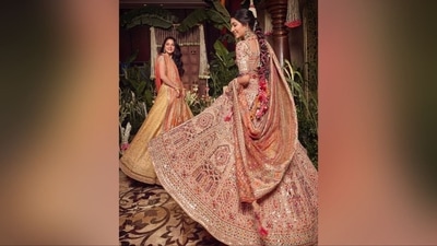 Radhika's outfit, designed by the renowned Tarun Tahiliani, features a mirror-adorned lehenga with a multicoloured blouse, matching flared skirt, and an enchanting dupatta, adding flair to her stunning look. (Instagram) Radhika's outfit, designed by the renowned Tarun Tahiliani, features a mirror-adorned lehenga with a multicoloured blouse, matching flared skirt, and an enchanting dupatta, adding flair to her stunning look. (Instagram)