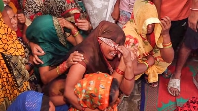 Relatives mourn the death of a victim in the stampede that occured during a religious congregation in Hathras on July 3. (PTI Photo) Relatives mourn the death of a victim in the stampede that occured during a religious congregation in Hathras on July 3. (PTI Photo)