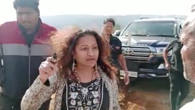 Screen grab from an undated video of IAS probationary officer Puja Khedkar's mother, Manorama, brandishing a small weapon. Screen grab from an undated video of IAS probationary officer Puja Khedkar's mother, Manorama, brandishing a small weapon.