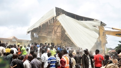 People and rescuers gather at the scene of a collapsed two-storey building in Jos, Nigeria, Friday, July, 12, 2024. (AP) People and rescuers gather at the scene of a collapsed two-storey building in Jos, Nigeria, Friday, July, 12, 2024. (AP)