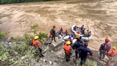 Two buses were swept into the Trishuli River by the landslides at Simaltal area along the Narayanghat-Mugling road in Chitwan district (PTI) Two buses were swept into the Trishuli River by the landslides at Simaltal area along the Narayanghat-Mugling road in Chitwan district (PTI)