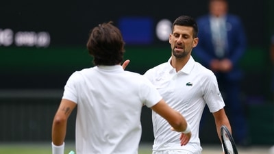 Serbia's Novak Djokovic shakes hands with Italy's Lorenzo Musetti after winning their semi final match (REUTERS)