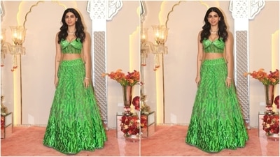 Khushi Kapoor wore a green lehenga to the wedding ceremony. She chose a plunging-neck bralette and lehenga skirt adorned in glittering sequins A choker, striking glam, and loose tresses completed the outfit. (HT Photo/Varinder Chawla ) Khushi Kapoor wore a green lehenga to the wedding ceremony. She chose a plunging-neck bralette and lehenga skirt adorned in glittering sequins A choker, striking glam, and loose tresses completed the outfit. (HT Photo/Varinder Chawla )