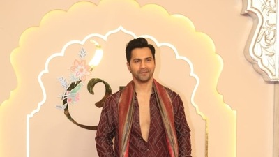 Varun Dhawan arrived in a brown sherwani, and posed for the paparazzi. 