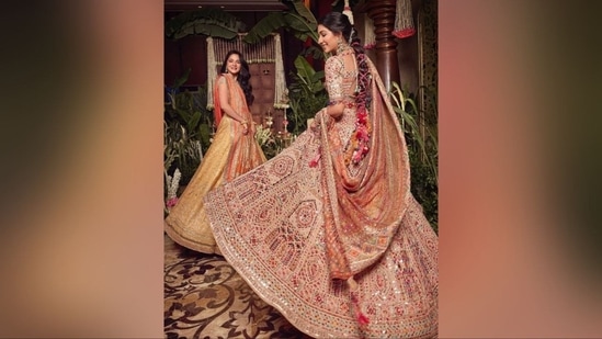 Radhika's outfit, designed by the renowned Tarun Tahiliani, features a mirror-adorned lehenga with a multicoloured blouse, matching flared skirt, and an enchanting dupatta, adding flair to her stunning look.(Instagram)