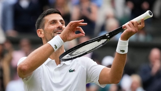 Novak Djokovic of Serbia reacts after defeating Lorenzo Musetti of Italy in their semifinal match at the Wimbledon tennis championships in London, Friday(AP)