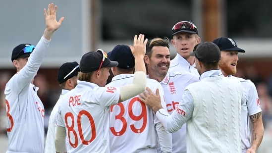 England's James Anderson (C) celebrates with teammates after the dismissal of West Indies Alick Athanaze during play on the second day of the first Test(AFP)