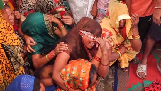 Relatives mourn the death of a victim in the stampede that occured during a religious congregation in Hathras on July 3. (PTI Photo)