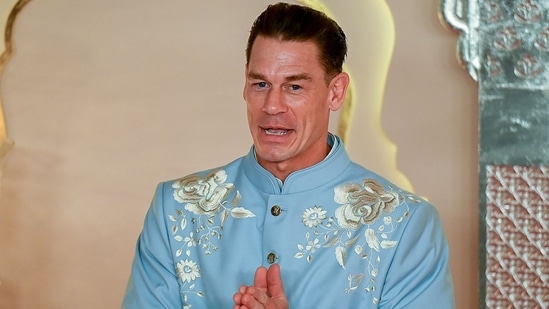 Hollywood actor John Cena gestures as he arrives for the wedding ceremony of Anant Ambani and Radhika Merchant in Mumbai. (Photo by Punit PARANJPE / AFP)(AFP)