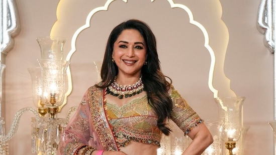 Madhuri Dixit poses for a photograph as she arrives at the wedding of Anant Ambani and Radhika Merchant at Jio World Convention Centre in Mumbai, India, Friday, July 12, 2024. (AP Photo /Rajanish Kakade)(AP)
