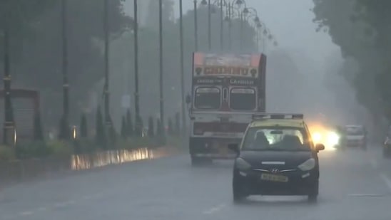 Visuals from P D'Mello Road shows heavy rainfall, with vehicles moving through the rain.(ANI)