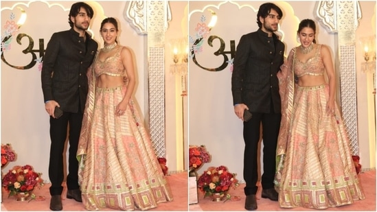 Sara Ali Khan and Ibrahim Ali Khan pose for the paps at the wedding venue. While Sara chose a blush pink silk lehenga set, Ibrahim looked dapper in a black bandhgala jacket, matching pants, and suede boots. (HT Photo/Varinder Chawla)