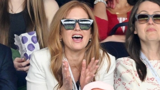 The actor spotted in the Evian suite screams sophistication in her navy sundress with a white accent to the outfit. (The Associated Press)