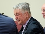 Actor Alec Baldwin, center, reacts as he sits between his attorneys Alex Spiro, left, and Luke Nikas after the judge threw out the involuntary manslaughter case for the 2021 fatal shooting of cinematographer Halyna Hutchins during filming of the Western movie "Rust," Friday, July 12, 2024, in Santa Fe, N.M. (Ramsay de Give/Pool Photo via AP)