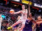 Indiana Fever guard Caitlin Clark (22) makes a pass over Phoenix Mercury forward Natasha Mack (4) in the second half of a WNBA basketball game in Indianapolis, Friday, July 12, 2024. (AP/Michael Conroy) Indiana Fever guard Caitlin Clark (22) makes a pass over Phoenix Mercury forward Natasha Mack (4) in the second half of a WNBA basketball game in Indianapolis, Friday, July 12, 2024. (AP/Michael Conroy)