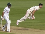 England's James Anderson, right, bowls a delivery past Pakistan's Babar Azam