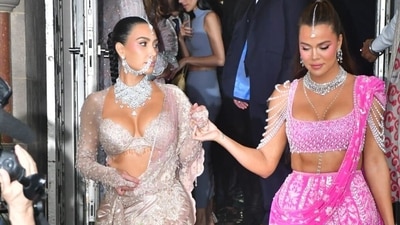 Kim and Khloe Kardashian flaunted their jaw-dropping traditional looks where Kim was seen decked up in a silver lehenga accessorised with an enormous diamond necklace, a big nathni and a maang tika while Khloe dazzled in a bright pink lehenga. (HT Photo) Kim and Khloe Kardashian flaunted their jaw-dropping traditional looks where Kim was seen decked up in a silver lehenga accessorised with an enormous diamond necklace, a big nathni and a maang tika while Khloe dazzled in a bright pink lehenga. (HT Photo)