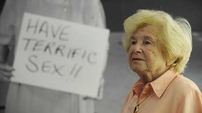 (FILES) German-born US author and sex therapist Ruth Westheimer, known as Dr. Ruth, poses in front of a photograph of herself holding a placard that reads "Have terrific sex" at the Frankfurt Book Fair on October 16, 2008. Westheimer, the wildly successful sex therapist who became a pop culture phenomenon in the 1980s with her bluntly delivered advice on how to spice up your life in the bedroom, has died, US media reported Saturday. She was 96. People magazine, quoting her publicist and sometime co-author Pierre Lehu, said she died on July 12, 2024. It gave no cause of death, but other reports said she died at home in New York City with family members present. (Photo by John MACDOUGALL / AFP) (AFP) (FILES) German-born US author and sex therapist Ruth Westheimer, known as Dr. Ruth, poses in front of a photograph of herself holding a placard that reads "Have terrific sex" at the Frankfurt Book Fair on October 16, 2008. Westheimer, the wildly successful sex therapist who became a pop culture phenomenon in the 1980s with her bluntly delivered advice on how to spice up your life in the bedroom, has died, US media reported Saturday. She was 96. People magazine, quoting her publicist and sometime co-author Pierre Lehu, said she died on July 12, 2024. It gave no cause of death, but other reports said she died at home in New York City with family members present. (Photo by John MACDOUGALL / AFP) (AFP)