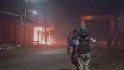 Security personnel stand guard after shops and houses were set on fire following the death of a tribal youth in Dhalai district in Tripura on Friday night. (PTI) Security personnel stand guard after shops and houses were set on fire following the death of a tribal youth in Dhalai district in Tripura on Friday night. (PTI)