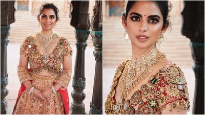 Isha paired the choli with an embroidered multi-panelled lehenga skirt and a matching dupatta. She brought the look together by wearing statement diamond earrings, a stunning layered necklace, kadhas, and lotus-adorned haath phool. (Instagram) Isha paired the choli with an embroidered multi-panelled lehenga skirt and a matching dupatta. She brought the look together by wearing statement diamond earrings, a stunning layered necklace, kadhas, and lotus-adorned haath phool. (Instagram)