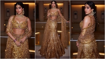 Janhvi's sleeveless temple gold jewellery bralette comes decked with gold jewel pieces, precious emerald and ruby stones, and floral arrangements. It features a plunging neckline, a midriff-baring hem, and a fitted bust. She paired the blouse with a matching sequin-embellished mermaid skirt adorned with a jewelled kamar bandh. (Instagram) Janhvi's sleeveless temple gold jewellery bralette comes decked with gold jewel pieces, precious emerald and ruby stones, and floral arrangements. It features a plunging neckline, a midriff-baring hem, and a fitted bust. She paired the blouse with a matching sequin-embellished mermaid skirt adorned with a jewelled kamar bandh. (Instagram)