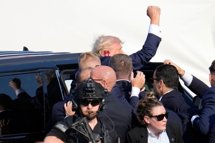 Republican presidential candidate former President Donald Trump pumps his fist as he is helped into a vehicle at a campaign event in Butler, Pa., on Saturday, July 13, 2024. (AP) Republican presidential candidate former President Donald Trump pumps his fist as he is helped into a vehicle at a campaign event in Butler, Pa., on Saturday, July 13, 2024. (AP)