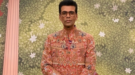 Bollywood's ace director and fashion lover Karan Johar reached the venue looking dapper in an embroidered red sherwani with multi-colour prints and pulled the attire off like only he could.(HT Photo)