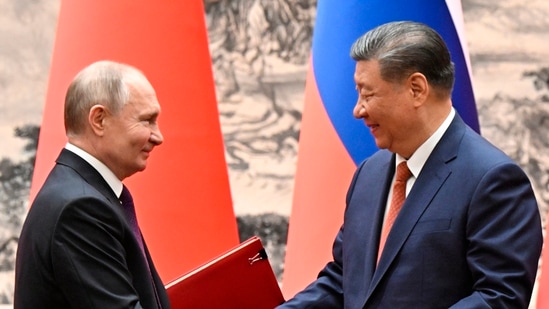 Chinese President Xi Jinping, right, and Russian President Vladimir Putin exchange documents after a signing ceremony during their meeting in Beijing, China. (AP)