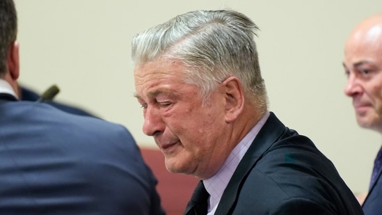 Actor Alec Baldwin, center, reacts as he sits between his attorneys Alex Spiro, left, and Luke Nikas after the judge threw out the involuntary manslaughter case for the 2021 fatal shooting of cinematographer Halyna Hutchins during filming of the Western movie "Rust," Friday, July 12, 2024, in Santa Fe, N.M. (Ramsay de Give/Pool Photo via AP)(AP)