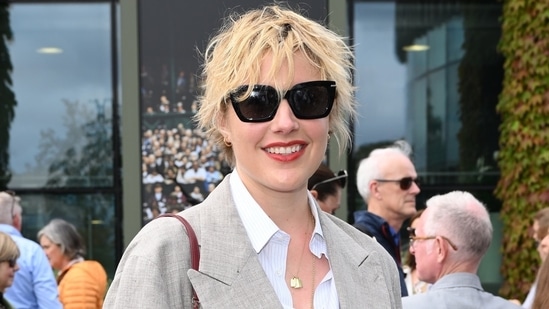 Barbie director Greta Gerwig exuded a cool vibe in a grey oversized suit and sunglasses.