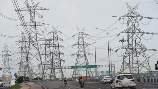 High-tension electric poles on SPR Road near Gurugram Sector 74A. (Parveen Kumar/HT Photo)