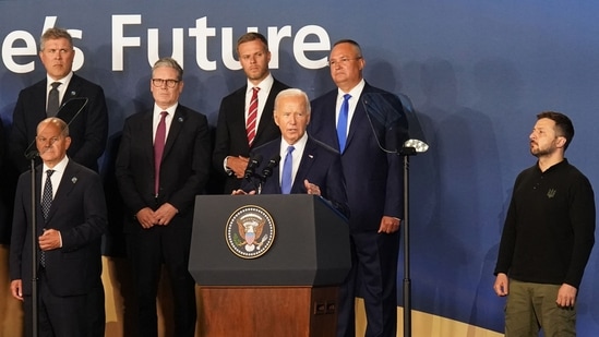 Ukraine's President Volodymyr Zelensky (R) listens as US President Joe Biden (C) speaks during the closing ceremony at the NATO 75th anniversary summit at the Walter E. Washington Convention Center in Washington, DC on July 11, 2024.(AFP)