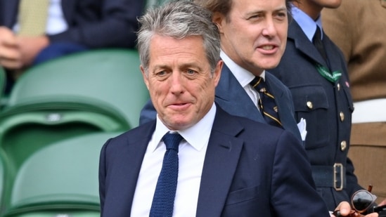 Hugh Grant looked relaxed and casual in a blue suit.