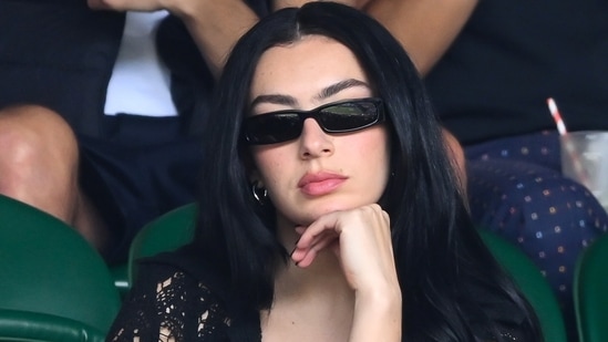 Singer Charli XCX, who looked cool in a black lace dress, seemed to be thoroughly enjoying the atmosphere at Wimbledon.