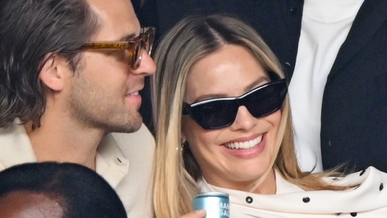 Margot Robbie looked great in a white mini-dress with black polka dots, and was spotted having a nice time with her husband.
