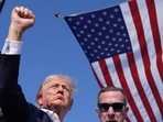 Donald Trump raising his fist in the air with blood dripping from his ear to his face. (AP) Donald Trump raising his fist in the air with blood dripping from his ear to his face. (AP)