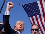 Donald Trump raising his fist in the air with blood dripping from his ear to his face. (AP)