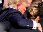 Republican presidential candidate, former President Donald Trump, is helped off the stage by U.S. Secret Service agents at a campaign event in Butler, Pa., on Saturday. (AP Photo/Gene J. Puskar)