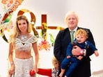 Former UK Prime Minister Boris Johnson attended Anant Ambani's wedding with his wife Carrie Symonds and their kids. Carrie held hands of their four-year-old son Wilfred and their two-year-old daughter Romy, while Boris held their one-year-old son Frank in his arms. Boris wore a black suit with a green tie and Carrie chose to go the Indian way by donning a white crop top and skirt with matching jewellery.