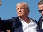 Donald Trump pumps his fist as he is rushed offstage by U.S. Secret Service agents after being grazed by a bullet during a rally on July 13, 2024 in Butler, Pennsylvania (Photo by Anna Moneymaker / GETTY IMAGES NORTH AMERICA / Getty Images via AFP) Donald Trump pumps his fist as he is rushed offstage by U.S. Secret Service agents after being grazed by a bullet during a rally on July 13, 2024 in Butler, Pennsylvania (Photo by Anna Moneymaker / GETTY IMAGES NORTH AMERICA / Getty Images via AFP)