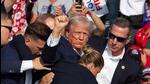 Republican candidate Donald Trump is seen with blood on his face surrounded by secret service agents as he is taken off the stage at a campaign event at Butler Farm Show Inc. in Butler, Pennsylvania, on Saturday. (AFP) Republican candidate Donald Trump is seen with blood on his face surrounded by secret service agents as he is taken off the stage at a campaign event at Butler Farm Show Inc. in Butler, Pennsylvania, on Saturday. (AFP)