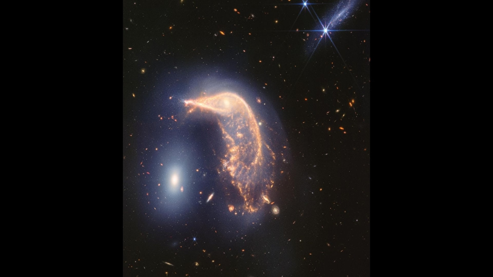 Stunning cosmic dance of 'the Penguin and the Egg' galaxies captured on NASA Webb anniversary. Watch